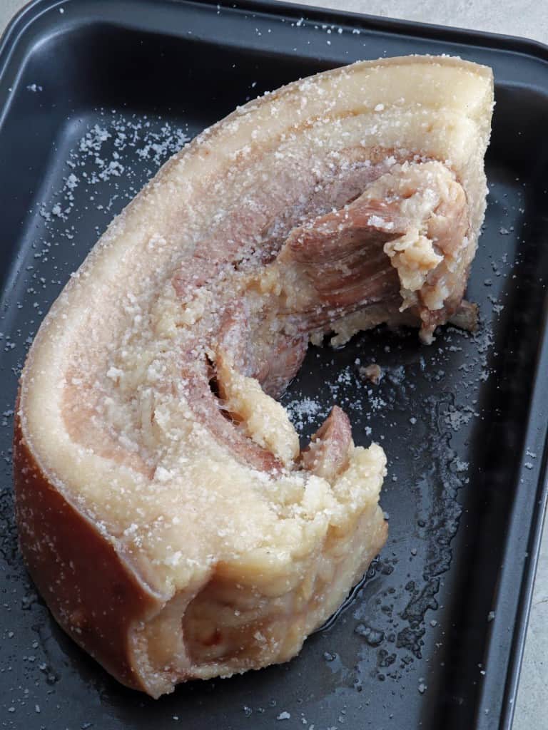 boiled pork belly slab on a baking sheet