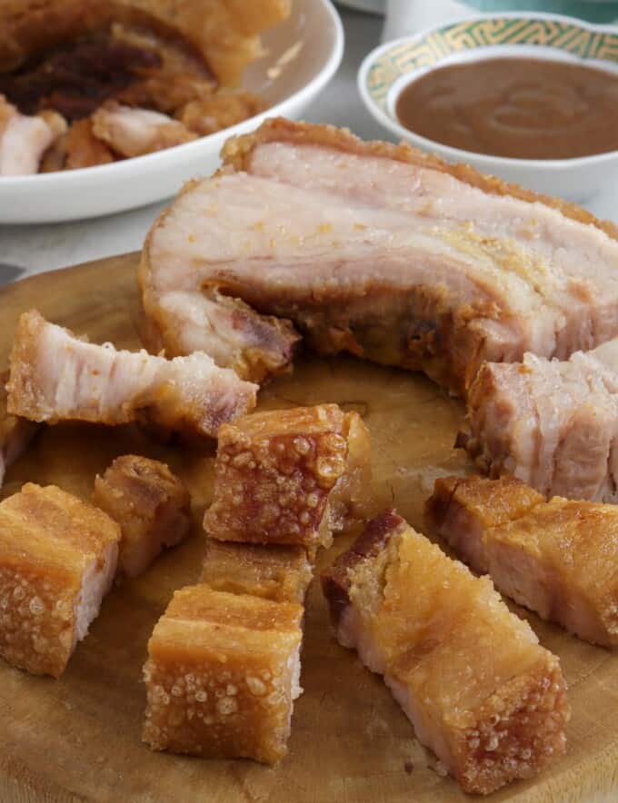 crispy pork belly on a wooden chopping board