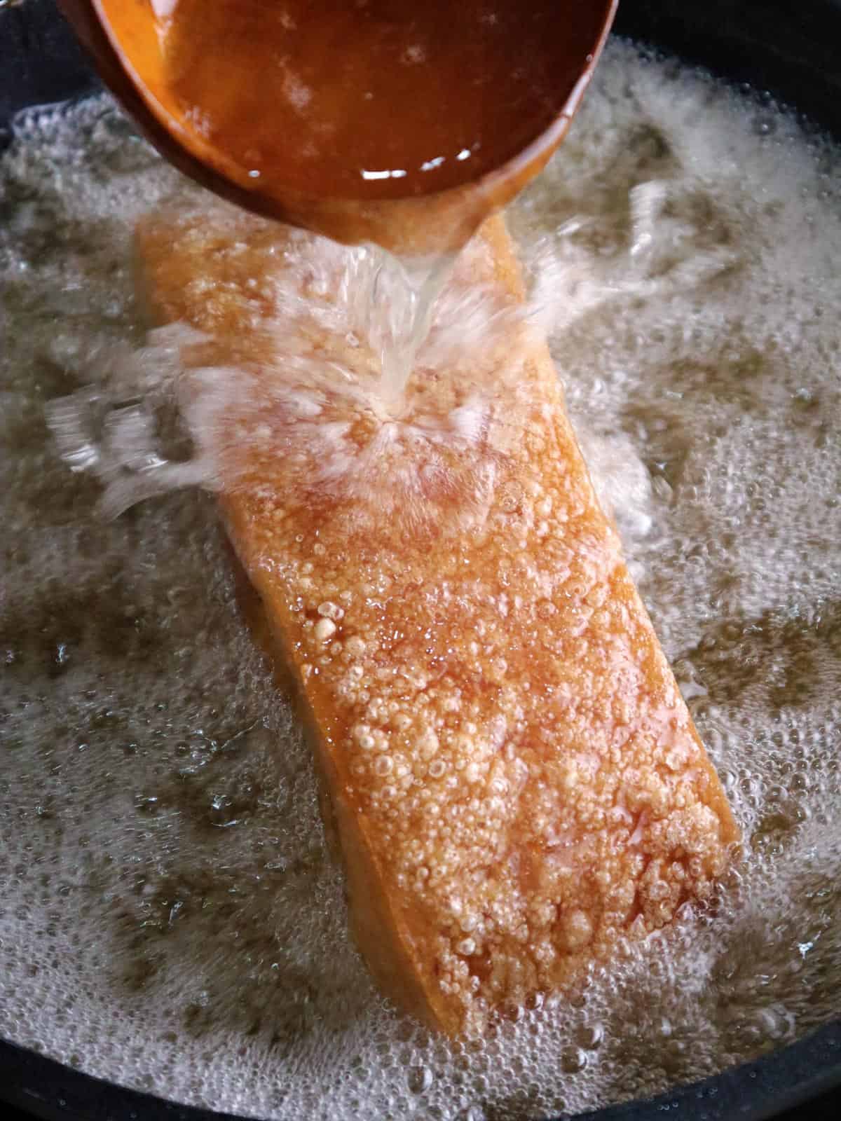 deep-frying pork belly in a pot