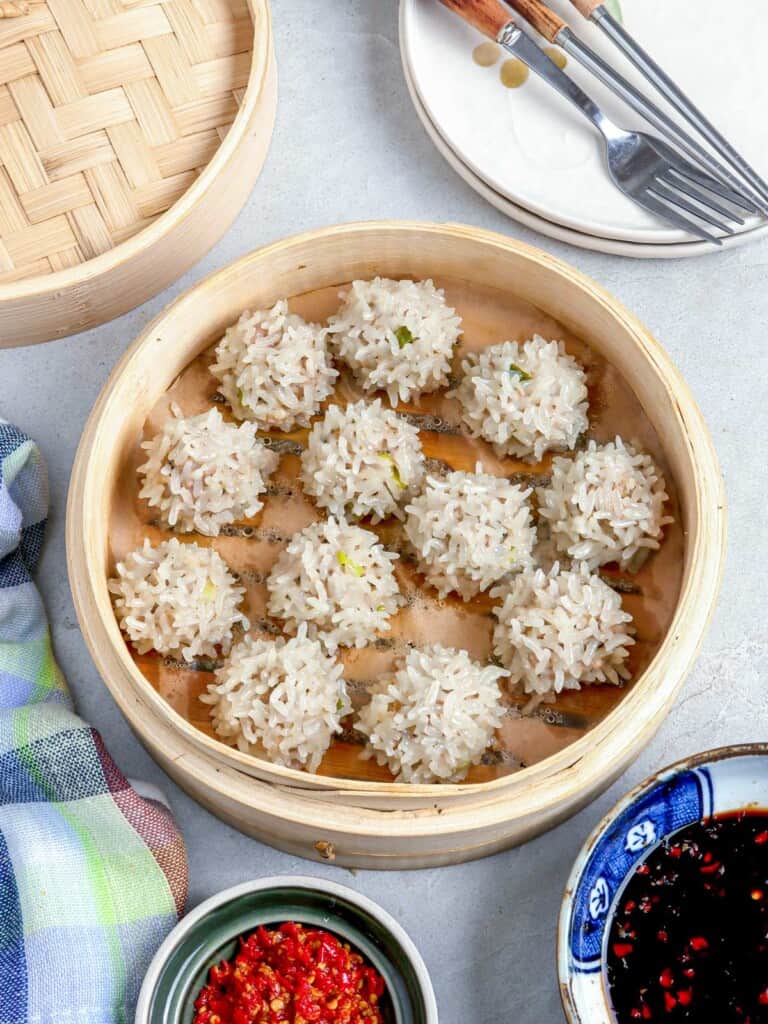 Edit Post Switch to draft Preview Update Image: Change block type or style Change alignment Replace Add title Chinese Pearl Balls Meaty and juicy with sticky rice coating, these Chinese Pearl Balls are super yummy and bursting with flavor. They're the perfect addition to a Chinese New Year celebration or any holiday menu. Chinese Pearl Balls on a plate with dipping sauce and steamer basket on the side Chinese Pearl Balls Table of Contents Filipino New Year celebrations are steeped in tradition and superstitions. I remember being a young child in tow as my mother frantically scoured grocery stores a day before New Year, in search of twelve kinds of round fruits to serve as a centerpiece for our festivities. I am sure you share my Media Noche memories of pancit guisado for long life or BBQ pork on a stick for prosperity. And, of course, dishes made with glutinous rice such as bringhe or biko to make good fortune "stick" throughout the coming year. How about banging on pots and pans and blowing on torotots? Or jumping up and down like crazy at the strike of midnight in polka dot undies? glutinous rice, ground pork, shitake mushrooms, soy sauce, onions, garlic What are Chinese Pearl Balls Chinese Pearl Balls are traditionally served on Chinese New Year to symbolize togetherness and reunion. The name comes from the fact they look like giant pearls, as the grains of rice turn pearly in color when cooked. These porcupine meatballs are basically made with pork meatball covered in sticky rice. The filling consists of ground pork, shitake mushrooms, water chestnuts, green onions and seasonings which are turned into small balls and then rolled in glutinous rice. These fun and tasty appetizers are similar to siomai when it come to the stuffing, the difference between them are how they are wrapped. Ingredient notes Glutinous Rice also known as sticky rice or sweet rice and are typically grown in Asian countries. It has a white grain that turns shiny, translucent and sticky when cooked. Dried Shiitake Mushrooms are commonly used in Chinese or other Asian cuisines. It adds an intense umami and smoky flavor and fragrance to any dish. Ground Pork or minced pork is usually made from pork shoulder or also known as the Boston butt or pork butt. You may substitute it with ground chicken, if preferred. Water Chestnuts are aquatic tuber vegetables grown in some parts of Asia, Africa and Australia. It resembles to an actual chestnut in color and shape, however it is not an actual nut. Ginger is hot and fragrant with a bamboo-like appearance. It is widely used as a spice, medicine and even as a delicacy. Green Onions also known as scallions are harvested young onions with bright green leaves and underdeveloped bulbs. Garlic is virtually used in the cuisines all over the world. It has a unique and intense flavor and aroma that makes it a popular flavoring agent. Soy Sauce is a dark brown liquid condiment that is considered to have a strong umami flavor. Chinese cooking wine also known as Shaoxing Wine is a rice wine usually used in Chinese cuisines. It has a harsh alcoholic flavor and is salty. In a pinch, you could substitute it with dry sherry, mirin or cooking sake. Sesame oil is derived from sesame seeds. It has a nutty, earthy flavor and used to enhance flavors in many dishes. Egg is used as a binder for the meat. Soak the glutinous rice in water for an hour to ensure the grains cook and absorb moisture evenly. Stir the meat mixture stirring in just one circular direction until it becomes sticky and fluffy. You can add chopped shrimp or ground fish fillet to the meat mixture for extra flavor. It is important to the line steamer to prevent the Chinese Pearl Balls from sticking. To Serve and store Serve the Chinese Pearl Balls warm with soy sauce-chili dipping sauce or sweet chili sauce. Store leftover meatballs in an airtight container and keep in the refrigerator for up to 4 days or in the freezer for up to 2 months. To reheat, steam the meatballs again. If using a microwave, place the pearl balls in a bowl and add a few drops of water. Cover the bowl with a plate, this will prevent the meatballs from drying out. Did you make this? Be sure to leave a review below and tag me @kawalingpinoy on Facebook and Instagram! Chinese Pearl Balls Prep Time: 20 mins Cook Time: 30 mins Total Time: 1 d Author: Lalaine Manalo Print Pin It Email Recipe 2 Dozens Ingredients 1 cup glutinous rice 2 pieces dried shitake mushrooms 1 pound ground pork 1/4 cup water chestnuts finely chopped 1 thumb-size ginger peeled and minced 2 green onions ends trimmed and chopped 2 cloves garlic peeled and minced 1 tablespoon soy sauce 1 tablespoon Chinese cooking wine 1 teaspoon sesame oil 1 egg beaten 1/2 teaspoon salt 1/4 teaspoon pepper Dipping Sauce soy sauce to taste chili sauce to taste Instructions In a bowl, combine glutinous rice and enough water to cover. Soak for at at least 6 hours or overnight for best results. In a colander, drain well and transfer into a wide plate. In a small bowl with warm water, soak shitake mushrooms until softened. Using hands, squeeze liquid and then mince. In a bowl, combine ground pork, water chestnuts, mushrooms, ginger, green onions, garlic, soy sauce, wine, sesame oil, egg, salt and pepper. Gently stir to combine. Form meat mixture into balls of about 1-inch diameter. Gently roll each ball in rice to fully coat, pressing rice onto meat. Line a steamer with wax paper or Chinese cabbage leaves. Arrange rice-coated meatballs in a single layer on steamer at about 1/2 inch apart. Steam for about 20 to 30 minutes or until rice and meat are cooked through. Serve with dipping sauce. Notes For moist meatballs, use ground pork with about higher percent of fat. If meat mixture is too soft to shape or roll in rice, freeze for about 10 to 15 minutes to firm up. “This website provides approximate nutrition information for convenience and as a courtesy only. Nutrition data is gathered primarily from the USDA Food Composition Database, whenever available, or otherwise other online calculators.” Did You Make This? Mention @KawalingPinoy and hashtag your photo with #KawalingPinoy Share Rate It ﻿ Toggle panel: Yoast SEO Premium SEO Readability Schema Social Focus keyphraseHelp on choosing the perfect focus keyphrase(Opens in a new browser tab) Chinese pearl balls Get related keyphrases(Opens in a new browser window) Google preview Preview as: Mobile resultDesktop result Url preview:www.kawalingpinoy.com › chinese-pearl-ballsSEO title preview: Chinese Pearl Balls - Kawaling Pinoy Meta description preview: Oct 10, 2014 － Traditionally served on Chinese New Year, chinese pearl balls are pork meatballs rolled in sticky rice and then steamed until rice cooks into a ... SEO title Insert variable Title Page Separator Site title Site title Title Primary category Separator Slug chinese-pearl-balls Meta description Insert variable Traditionally served on Chinese New Year, chinese pearl balls are pork meatballs rolled in sticky rice and then steamed until rice cooks into a pearl-white coating Site title Title Primary category Separator SEO analysisGood Chinese pearl balls Add related keyphrase Cornerstone content Insights Advanced Toggle panel: AdThrive Ads Disable all ads Disable content ads Disable auto-insert video players Re-enable ads on All ads on this post will be enabled on the specified date Disable Video Metadata Disable adding metadata to video player on this post Toggle panel: Scripts Header Scripts Output before the closing head tag, after sitewide header scripts. Body Scripts Body Scripts Position Bottom: before closing body tag Toggle panel: Grow: Share Options Social Media Image Select Image Social Media Title70 Characters Remaining Write a social media title... Social Media Description200 Characters Remaining Write a social media description... Pinterest Image Select Image Pinterest Title70 Characters Remaining Write a custom Pinterest title... Please note: Pinterest does not yet support pin titles. Pinterest is still in the process of releasing this feature. We've added the field in advance, to make sure you're ready for when the feature rolls out. Pinterest Description500 Characters Remaining Write a custom Pinterest description... Custom Tweet256 Characters Remaining Write a custom tweet... Maximum characters is based off of the Twitter maximum, the post permalink, and whether your Twitter username is included in the tweet. Display Options Hide buttons for theInline ContentFloating SidebarPop-UpFollow WidgetSticky Bar Show buttons for theInline ContentFloating SidebarPop-UpFollow WidgetSticky Bar Toggle panel: Grow: Share Statistics NetworkShares|% Facebook 16|5.06 Pinterest 300|94.94 Total shares316 Refresh shares Social Shares Recovery If you have ever modified the permalink for this particular post and want to recover lost shares for any previous links this post had, add the old links by pressing the Add Link button. Add Link Toggle panel: Related Posts Add Related Posts Sticky Rice Balls with Peanuts Edit Post | Unlink Related Post Bacon Fried Rice Edit Post | Unlink Related Post Java Rice Edit Post | Unlink Related Post Filipino Pork Barbecue Edit Post | Unlink Related Post Post Block Image Insert an image to make a visual statement. Styles This image has an empty alt attribute; its file name is MtBlanc1.jpg Mont Blanc appears—still, snowy, and serene. Default This image has an empty alt attribute; its file name is MtBlanc1.jpg Mont Blanc appears—still, snowy, and serene. Rounded Default Style Not set Grow by Mediavine Pin Title Chinese Pearl Balls Please note: Pinterest does not yet support pin titles. Pinterest is still in the process of releasing this feature. We've added the field in advance, to make sure you're ready for when the feature rolls out. Pin Description celebration or any holiday menu. Pin Repin ID Disable Pinning Image settings Alt text (alternative text) Chinese Pearl Balls on a plate with dipping sauce and steamer basket on the side Describe the purpose of the image(opens in a new tab)Leave empty if the image is purely decorative. Image size Large Image dimensions Width 768 Height 1024 25%50%75%100% Reset Advanced Skip to the selected block Open publish panel Document Image NotificationsNumber of media items found: 9NerdPress Help Close dialog Select or Upload Media Upload filesMedia Library Expand Details Filter mediaFilter by date All dates Search Chinese Pearl Balls Media list Showing 6 of 6 media items ATTACHMENT DETAILS Saved. pearl-balls-5.jpg October 27, 2021 249 KB 1200 by 1600 pixels Edit Image Delete permanently Alt Text Chinese pearl balls in a steamer Describe the purpose of the image(opens in a new tab). Leave empty if the image is purely decorative.Title Chinese Pearl Balls Caption Description Chinese pearl balls in a steamer File URL: https://www.kawalingpinoy.com/wp-content/uploads/2014/10/pearl-balls-5.jpg Copy URL to clipboard Required fields are marked * Grow Social by Mediavine: Pin Title Chinese Pearl Balls Please note: Pinterest does not yet support pin titles. Pinterest is still in the process of releasing this feature. We've added the field in advance, to make sure you're ready for when the feature rolls out. Grow Social by Mediavine: Pin Description Grow Social by Mediavine: Pin Repin ID Grow Social by Mediavine: Disable Pinning No Regenerate Thumbnails Regenerate Thumbnails Selected media actionsSelect
