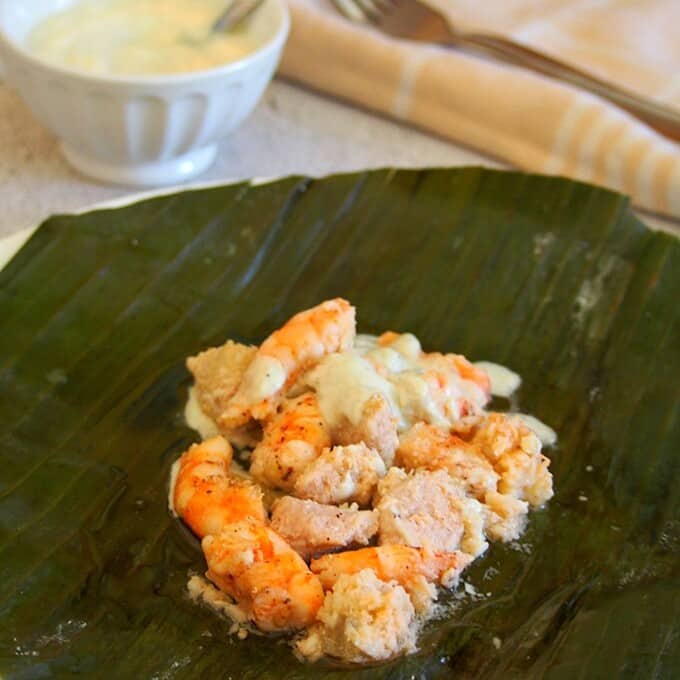Pinais na Hipon on a serving plate with a bowl of coconut sauce on the side