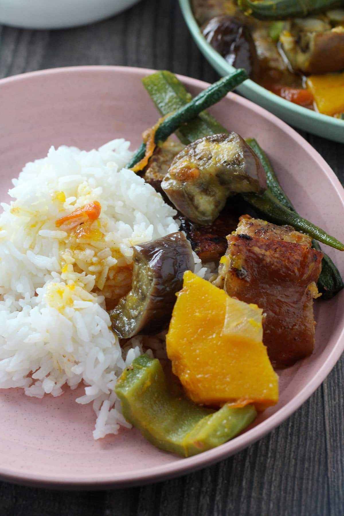 vegetable stew with crispy pork with steamed rice on a plate