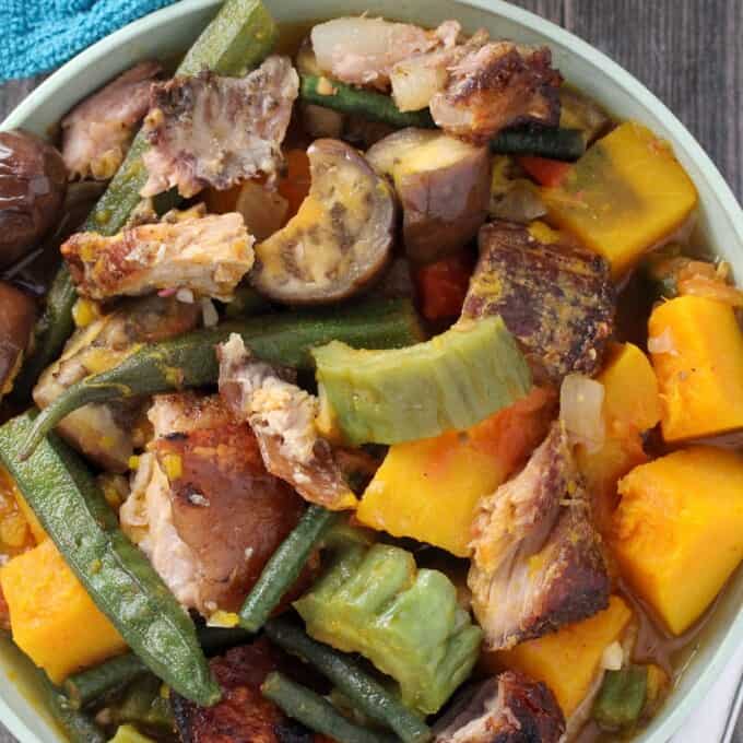 Pinakbet with Crispy Lechon in a white serving bowl