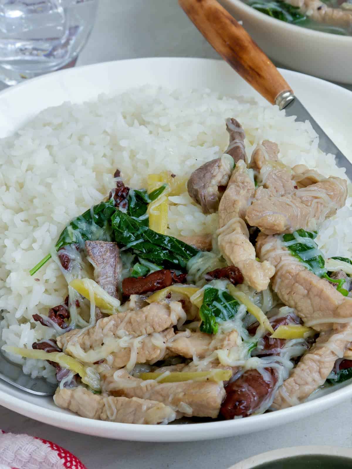 Batchoy Tagalog over rice on a white plate