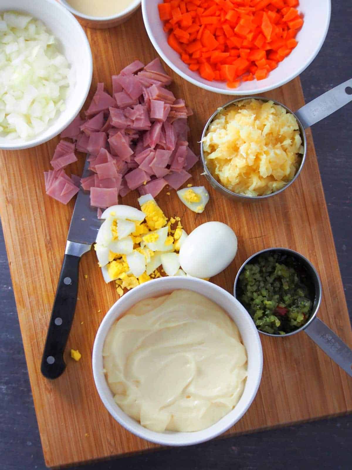 chopped ham, boiled eggs, diced carrots, crushed pineapple, chopped onions, mayonnaise, sweet relish