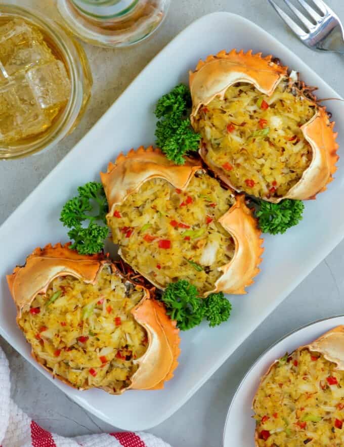 Rellenong Alimango on a white platter with a glass of beer on the background.