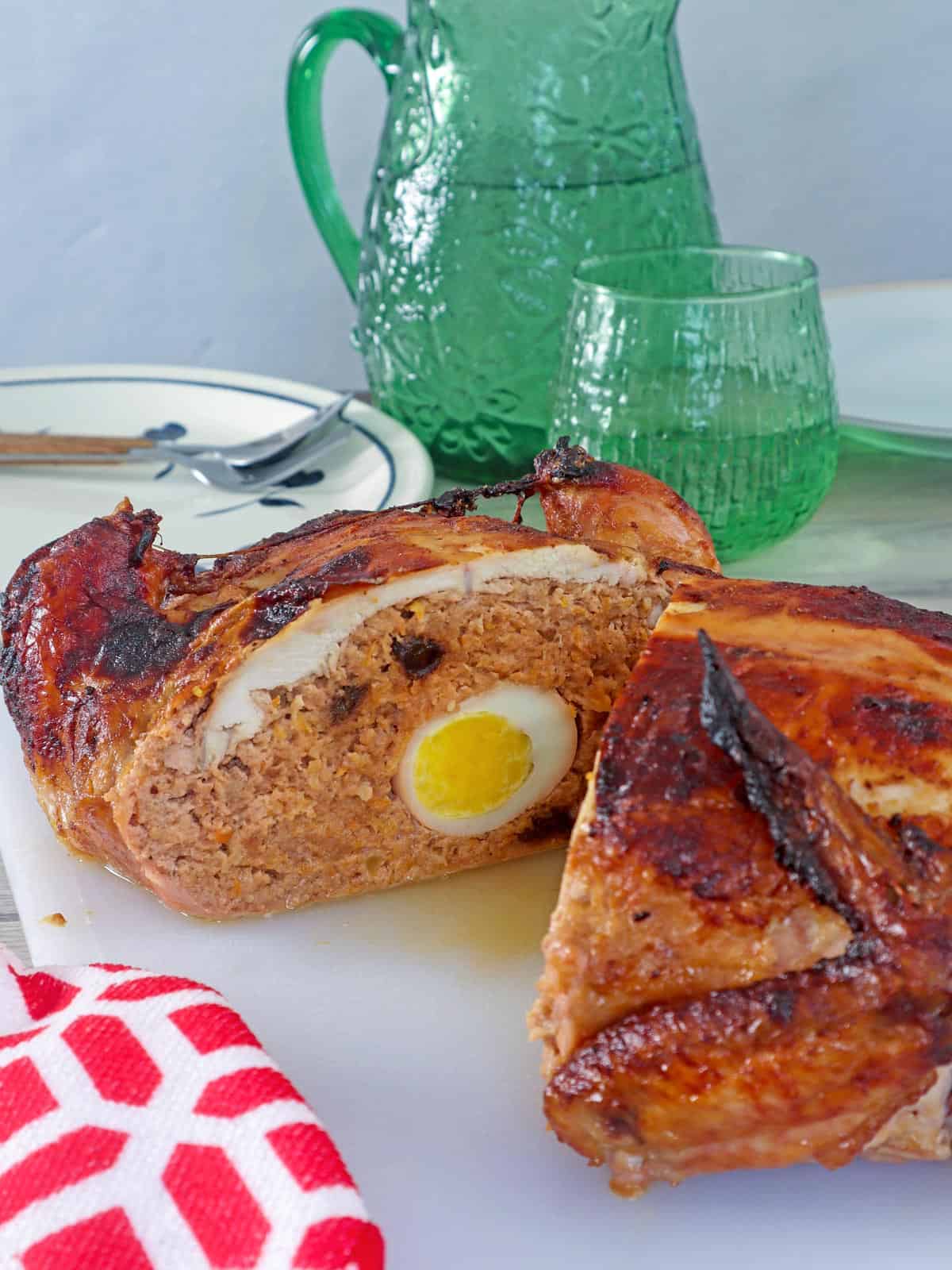 cut rellenong manok on a cutting board