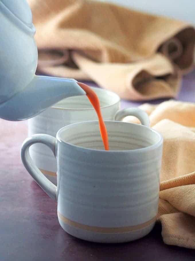 pouring hot tsokolate into a white cup