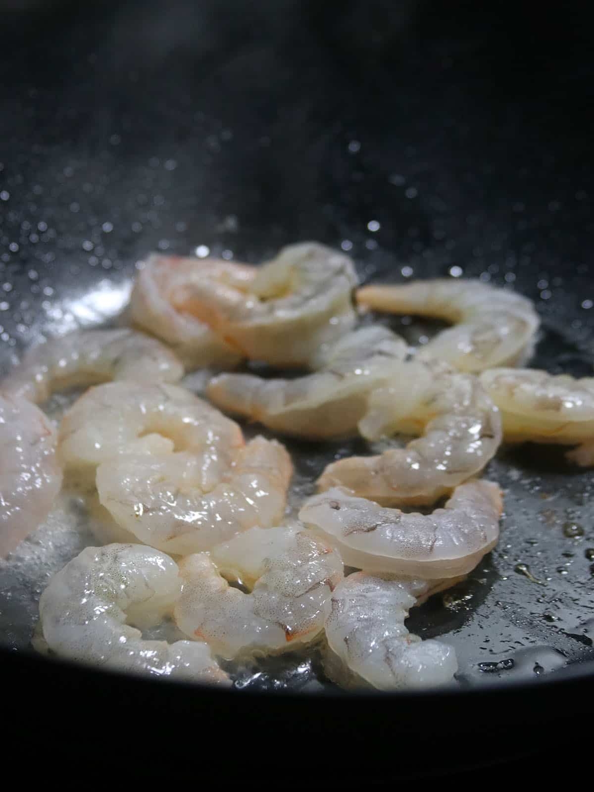 stir-frying shrimp in a wok