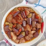 eggplant stew with shrimp paste and pork belly in a white serving bowl