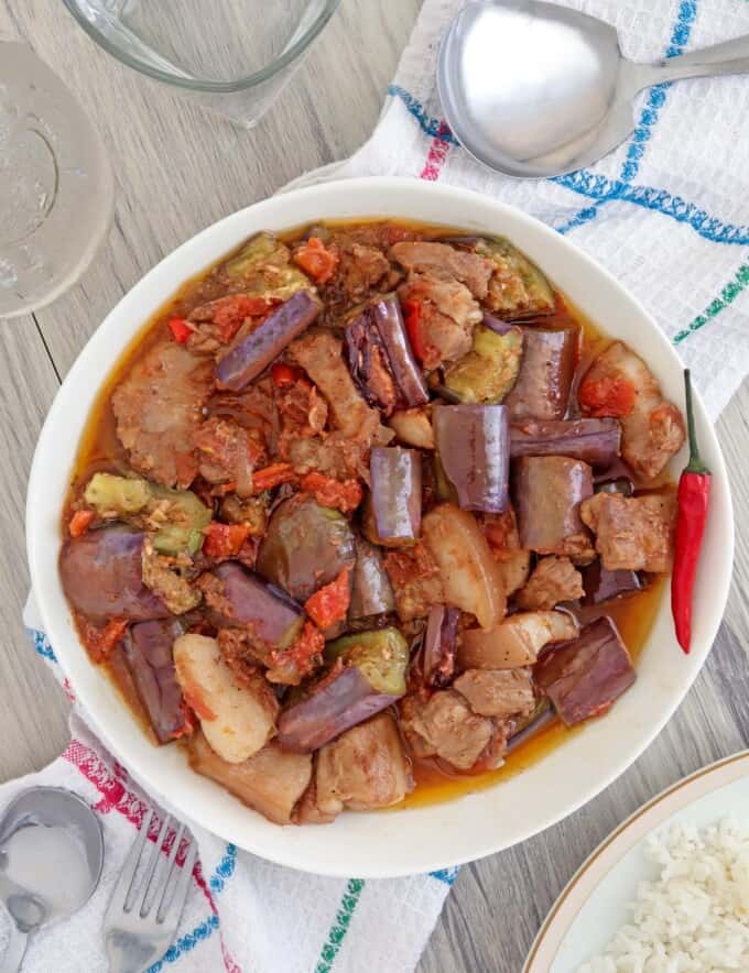 eggplant stew with shrimp paste and pork belly in a white serving bowl