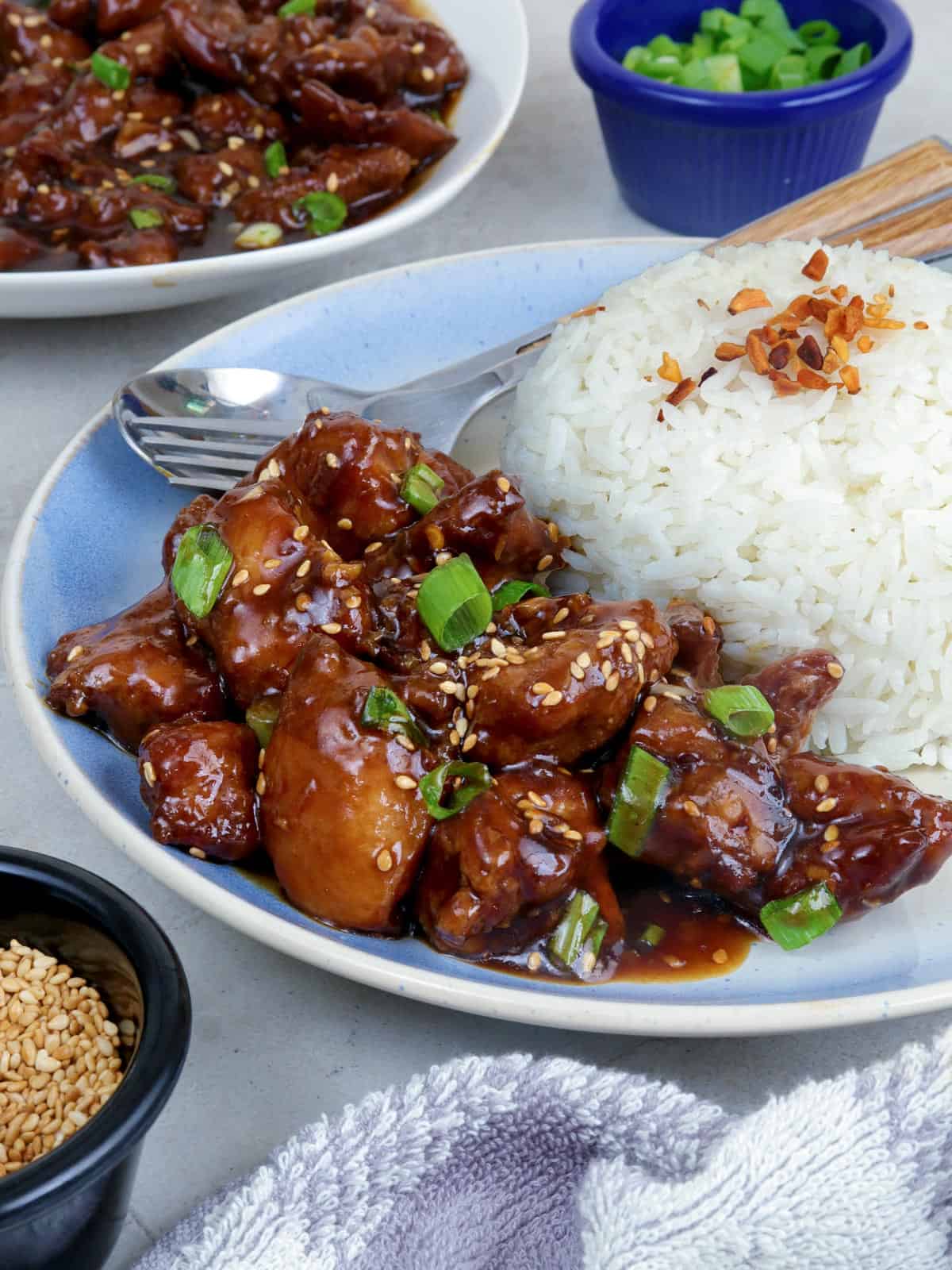 Calamansi Chicken on a white serving platter with steamed rice