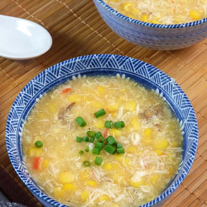 creamy corn crab soup in blue bowls.