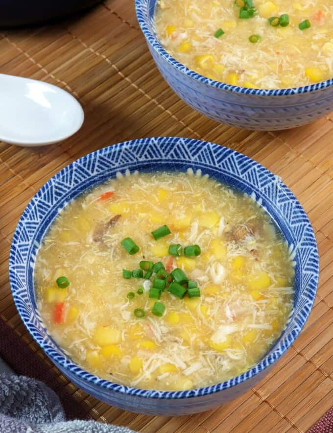 creamy corn crab soup in blue bowls.