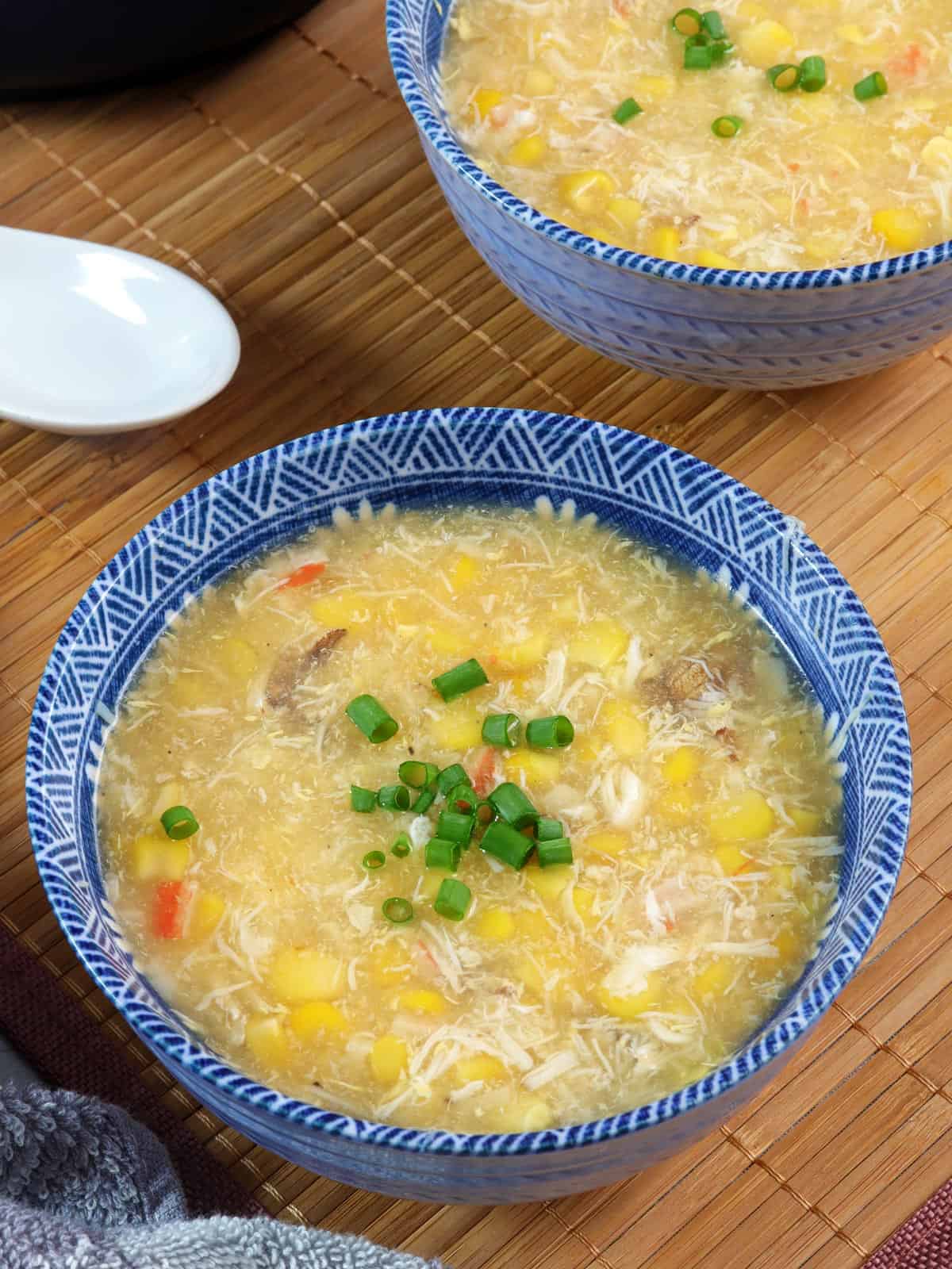 creamy corn crab soup in blue bowls.