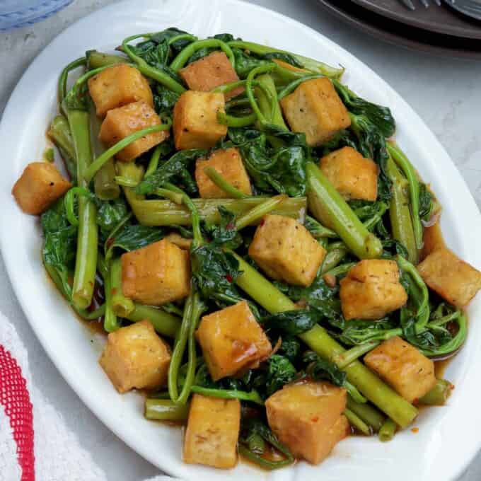 Kangkong and Tofu with Oyster Sauce on a white serving platter