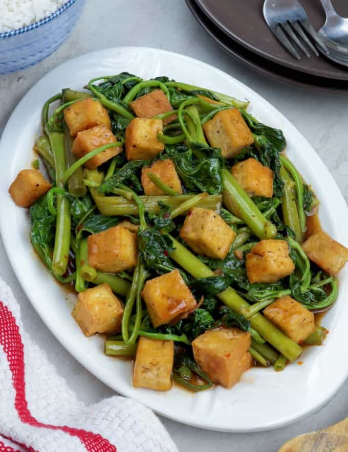 Kangkong and Tofu with Oyster Sauce on a white serving platter