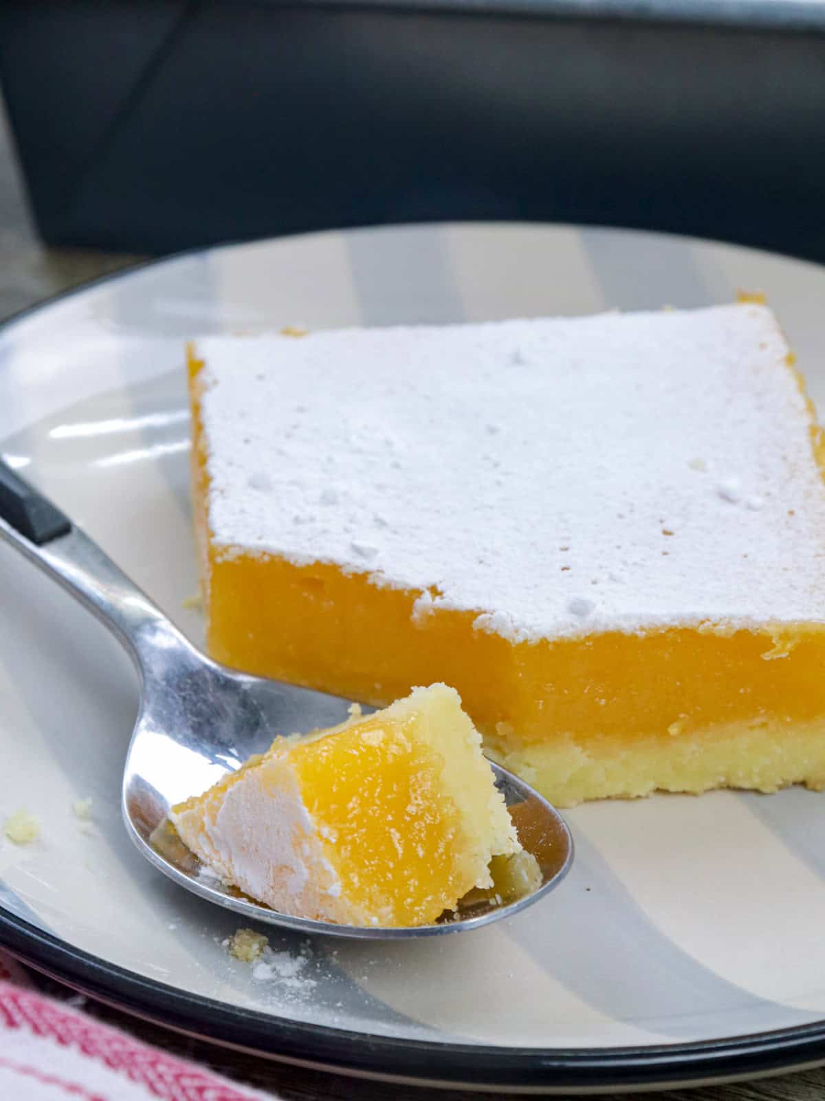 eating calamansi bars on a plate with a spoon.