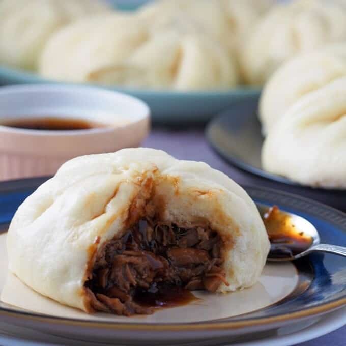 siopao with pork asado filling on a white serving plate