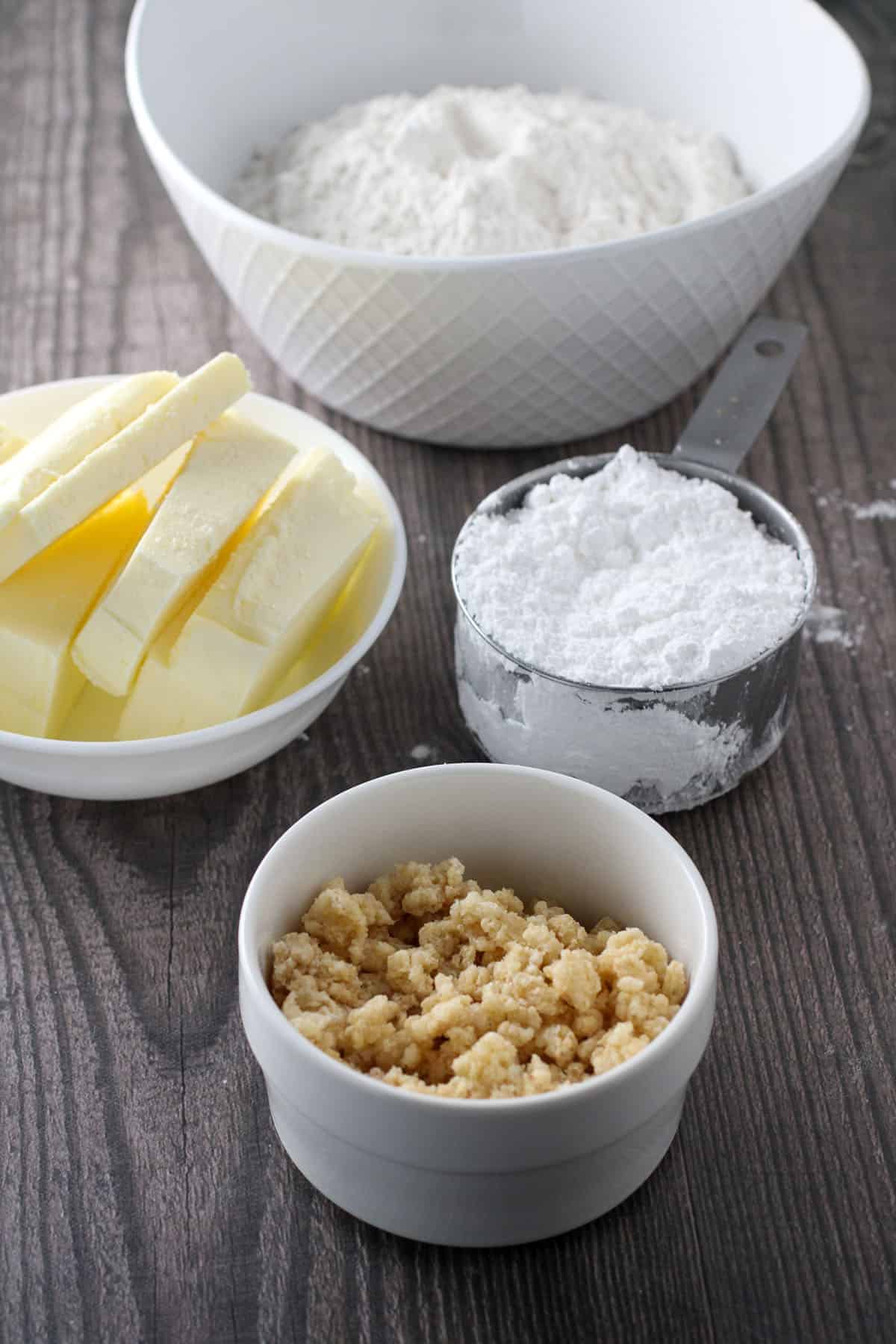 butter, confectioner's sugar, flour in bowls.