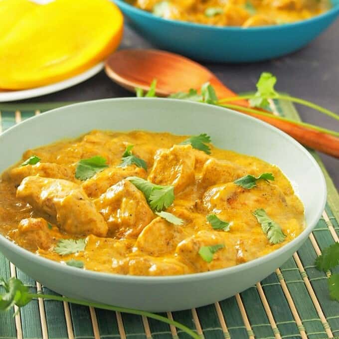 Mango Curry Chicken in a light blue serving bowl