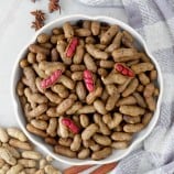 slow cooker peanuts in a white bowl