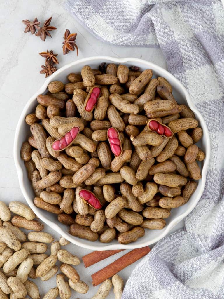 slow cooker peanuts in a white bowl