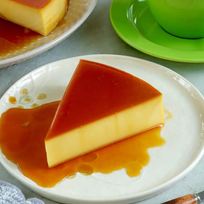 slice of cream cheese flan on a serving plate