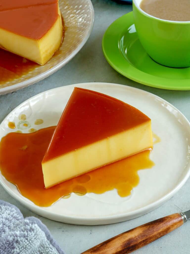 slice of cream cheese flan on a serving plate
