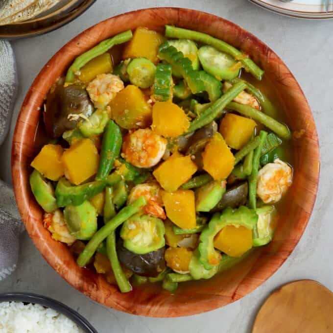 Filipino vegetable stew in a bowl with fried fish and steamed rice on the side