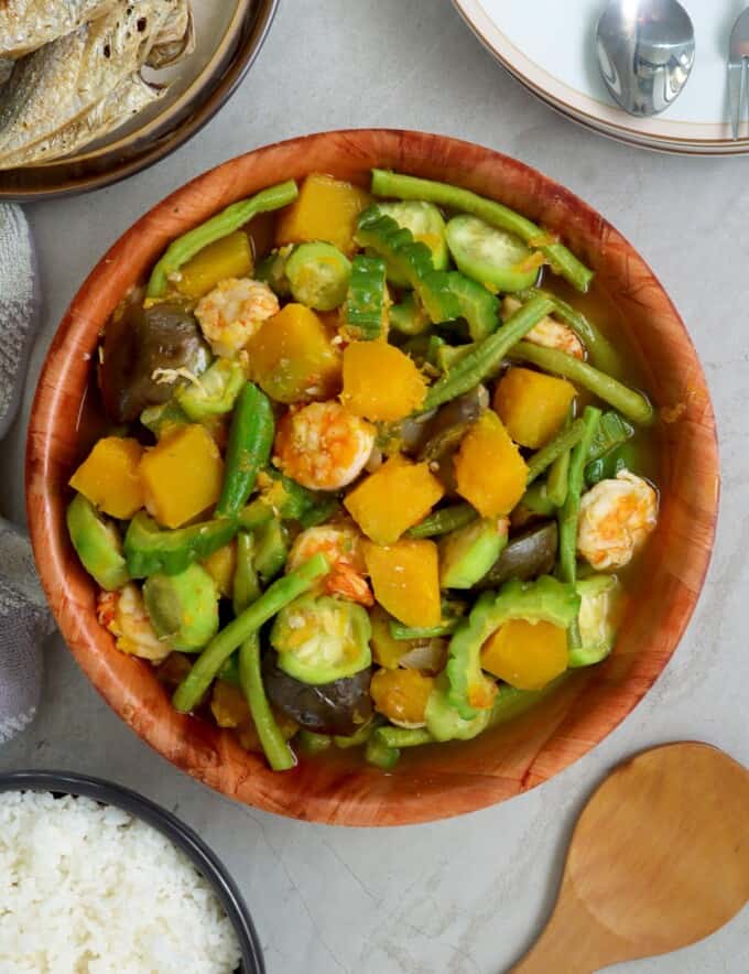 Filipino vegetable stew in a bowl with fried fish and steamed rice on the side