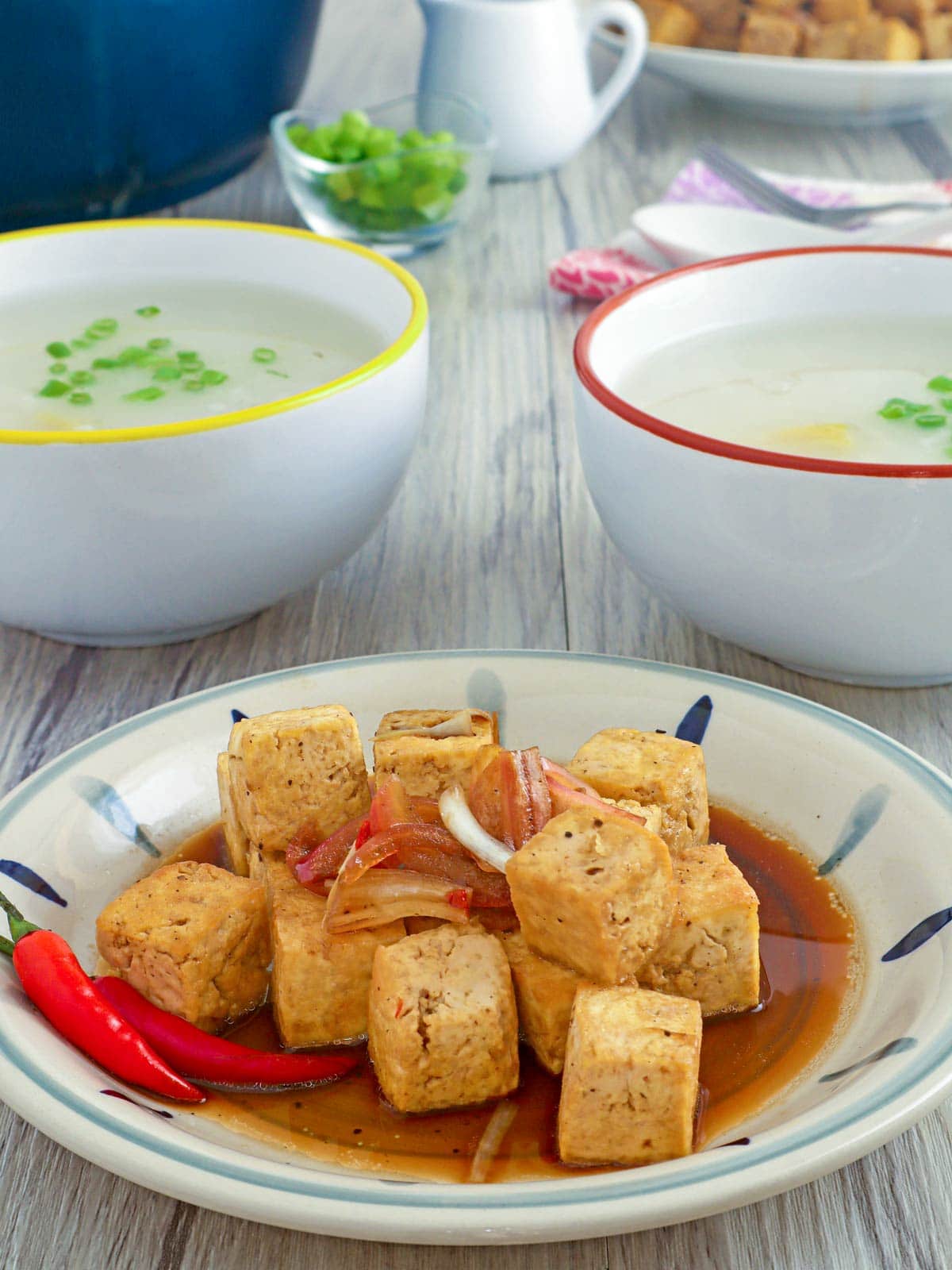 deep-fried tofu with soy sauce-vinegar dressing with a bowl of congee on the side