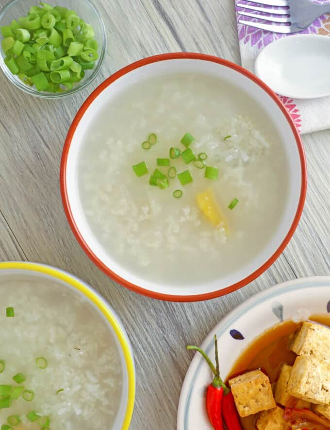 lugaw in a bowl with sizzling tofu on the side