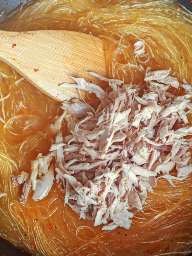 cooking sotanghon with shredded chicken