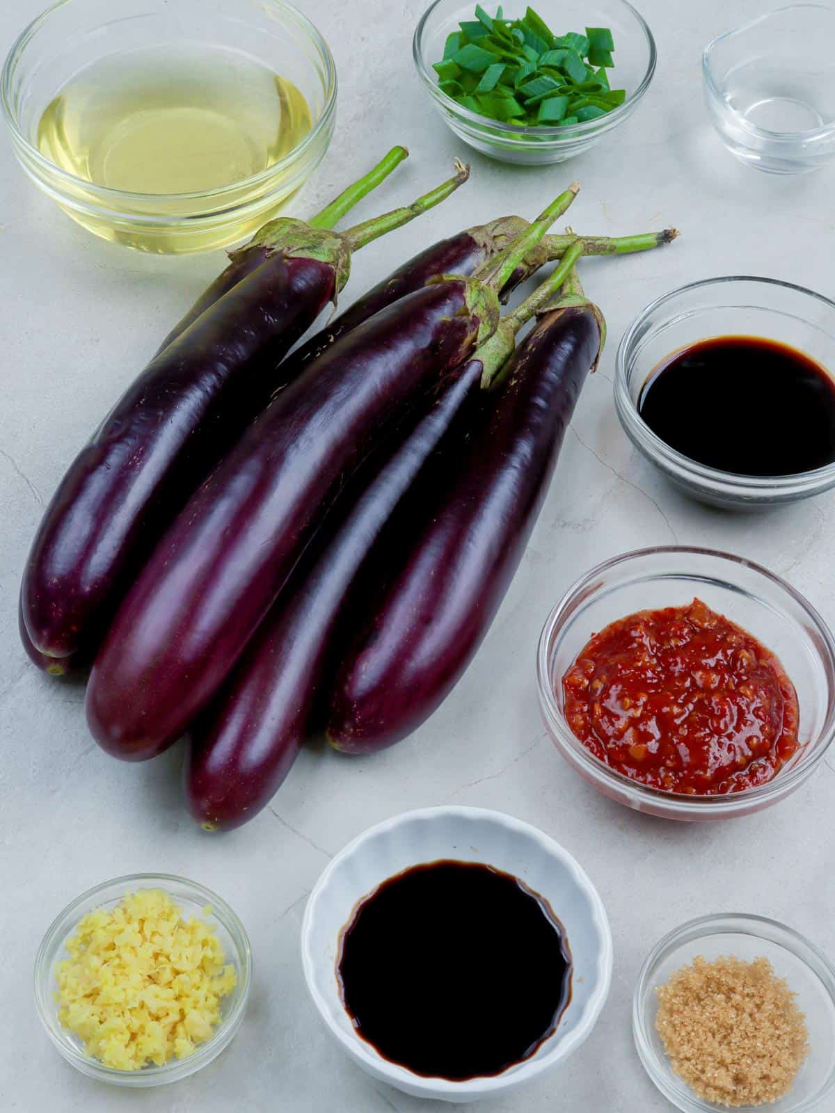 eggplants, chili garlic sauce, soy sauce, balsamic vinegar, ginger, oil, green onions, brown sugar in bowls