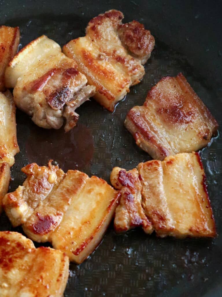 frying pork belly in a pan