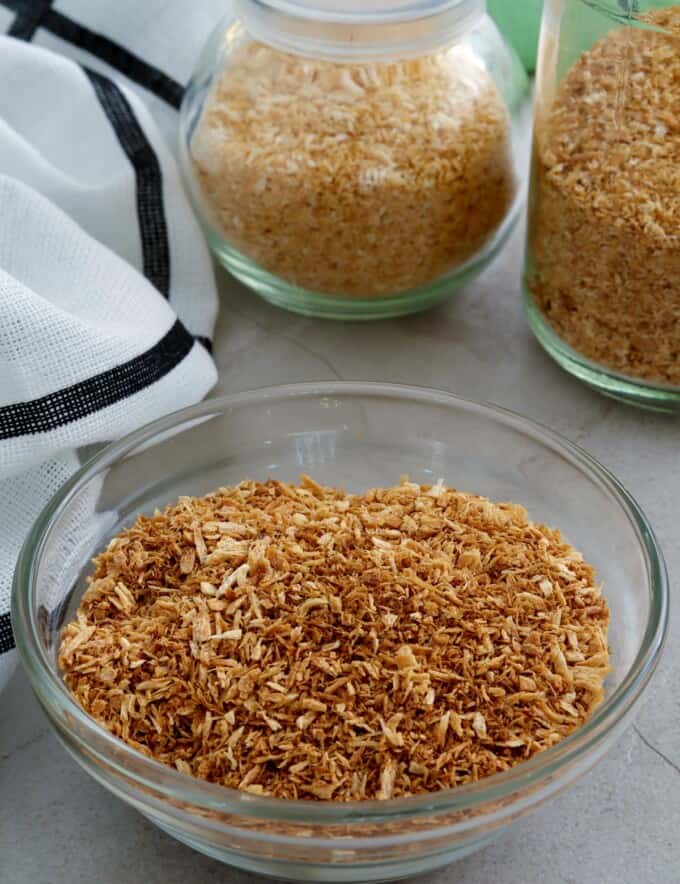 toasted coconut flakes in jars and bowl