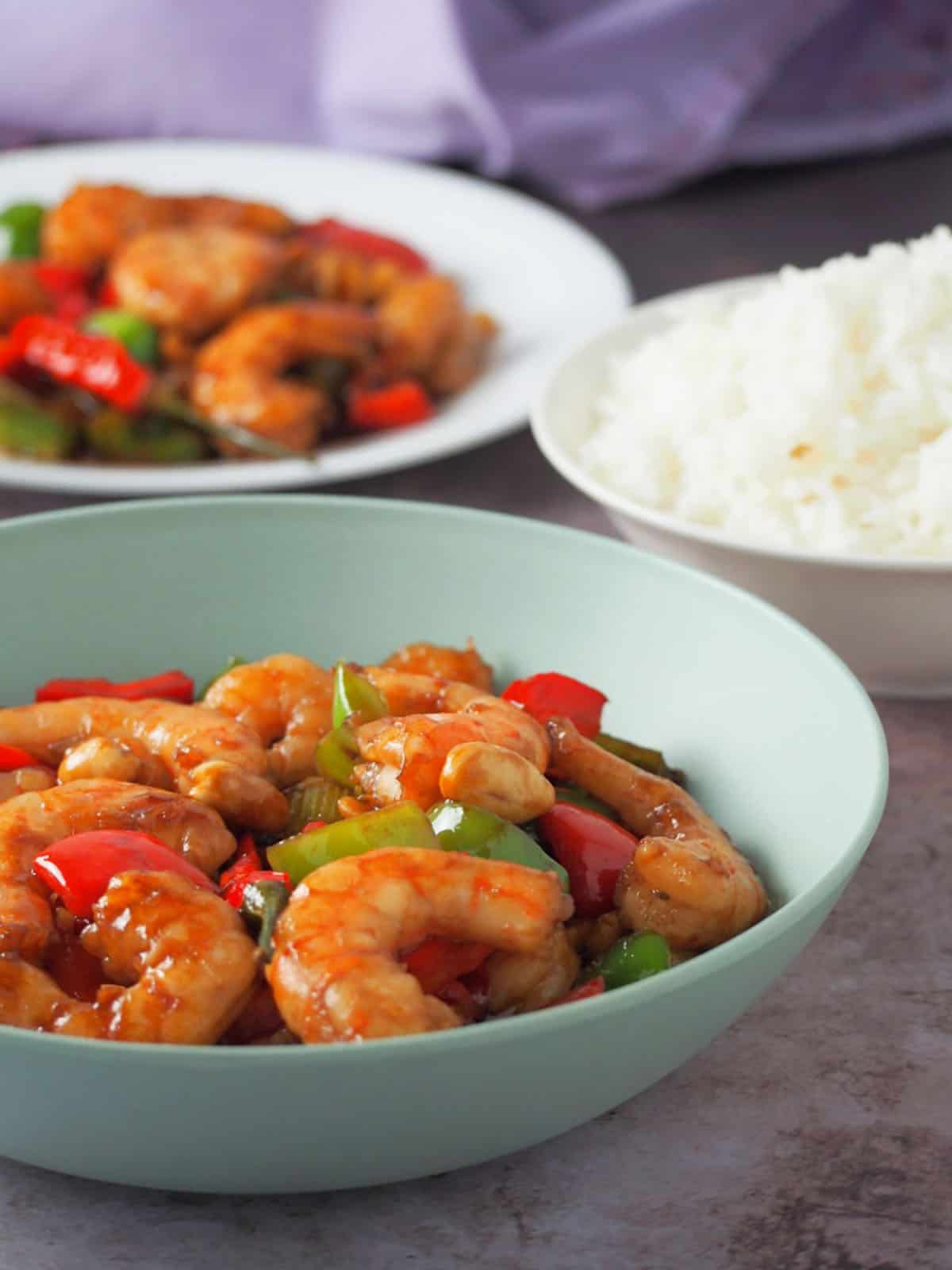 Kung Pao Shrimp in a bowl with steamed rice on the side