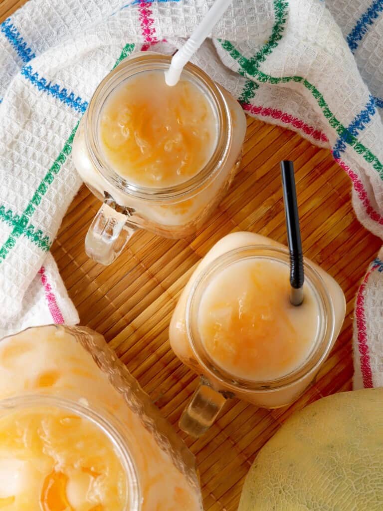 cantaloupe drink with condensed milk in a mason jar