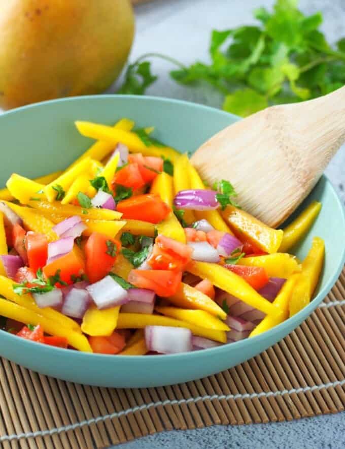 ensaladang manga with tomatoes in a serving bowl