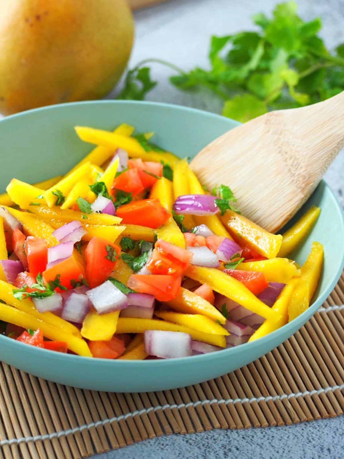 ensaladang manga with tomatoes in a serving bowl