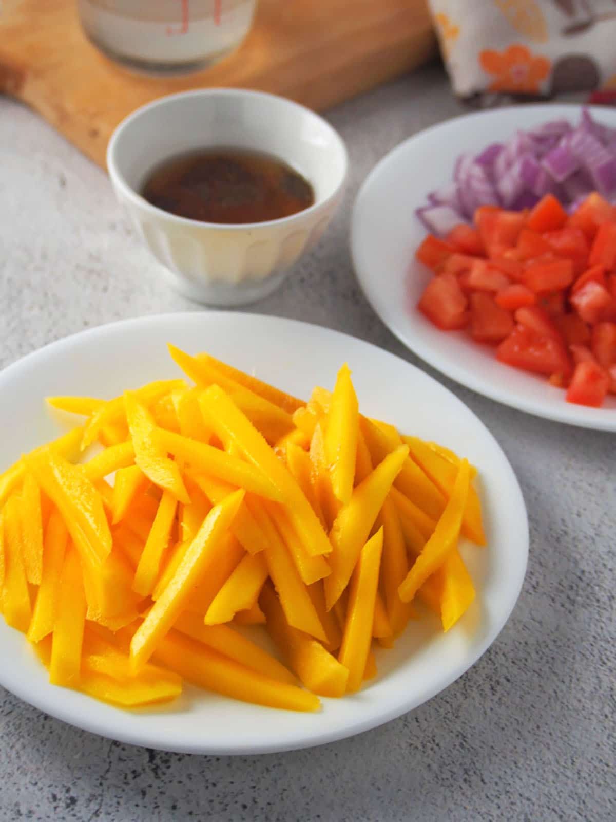 julienned mangoes, chopped tomatoes, chopped red onions, fish sauce, vinegar