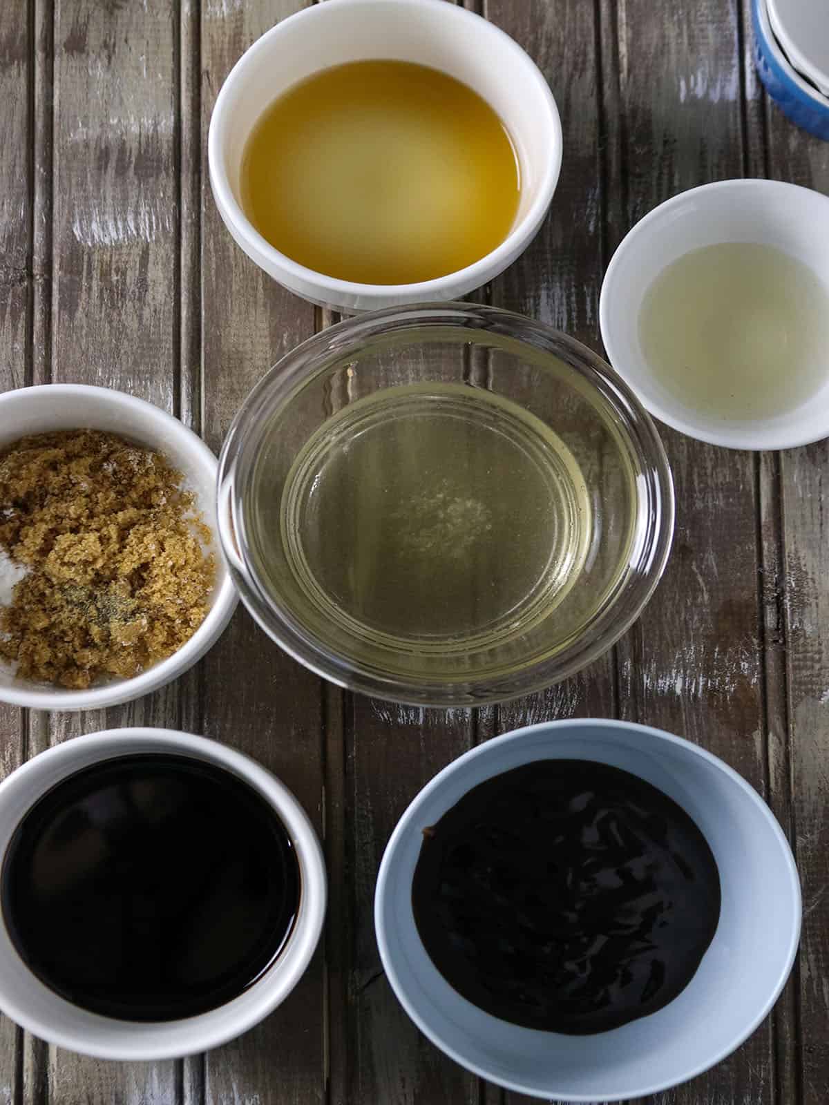 brown sugar, chicken broth, cooking wine, soy sauce, oyster sauce, sesame oil in bowls