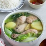 Pesang Manok in a serving bowl with a side of steamed rice and fish sauce