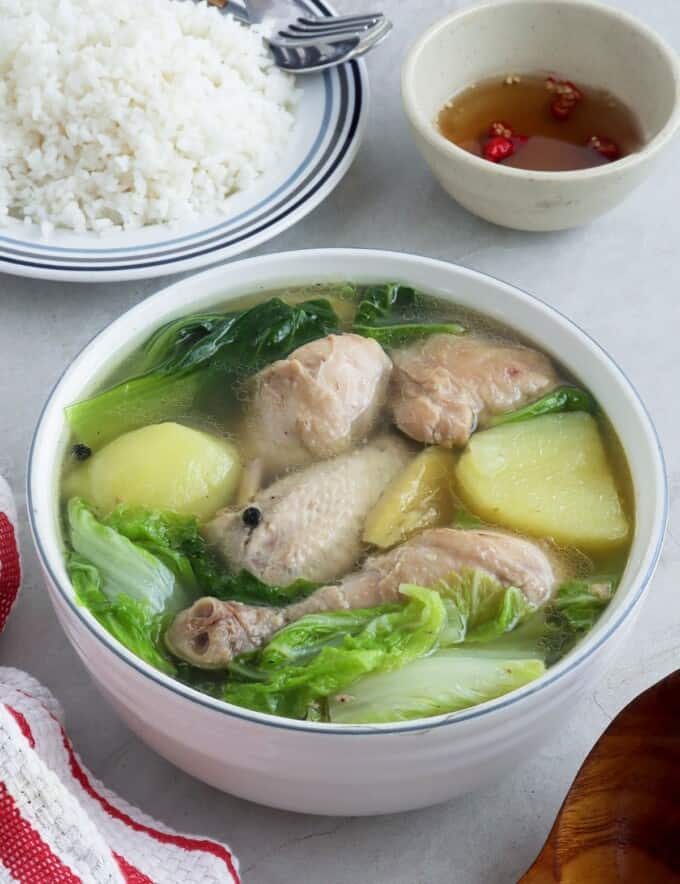 Pesang Manok in a serving bowl with a side of steamed rice and fish sauce