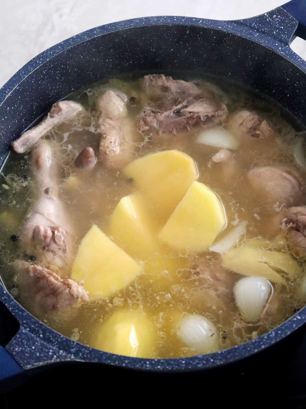 cooking pesang manok in a pot