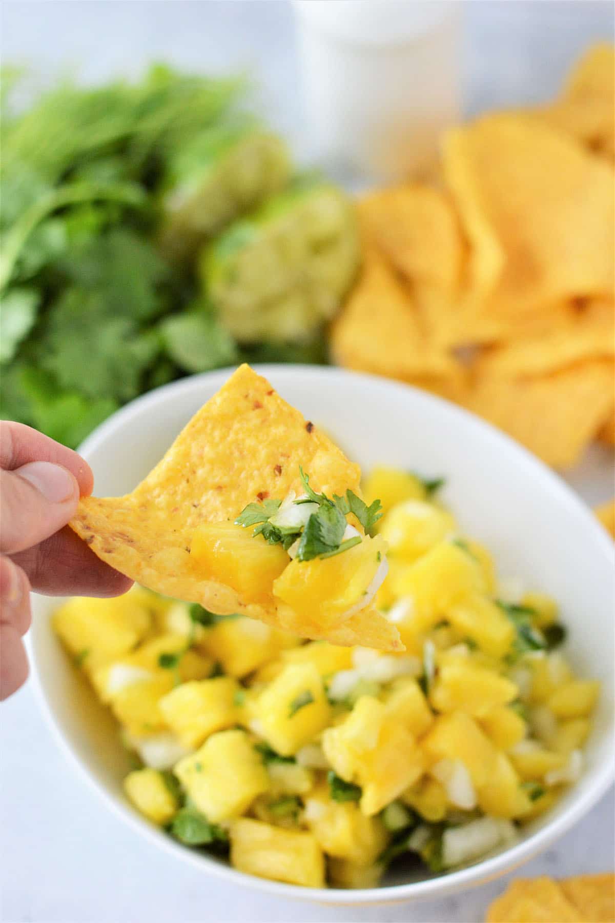 dipping chips in pineapple salsa