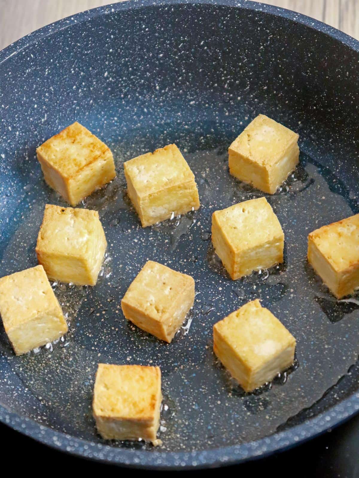 pan-frying tofu in a pan