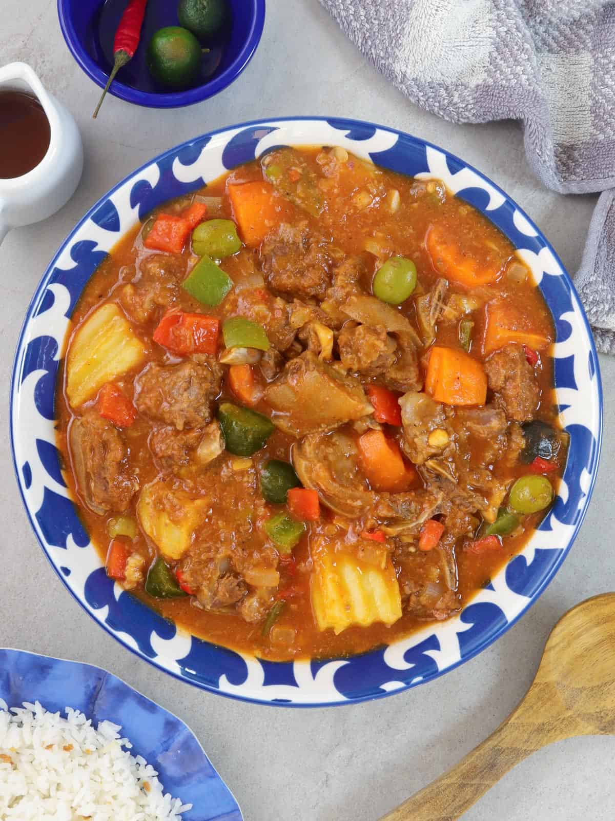 Kalderetang Kambing in a blue serving bowl