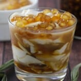 Taho in a clear glass with brown syrup and sago